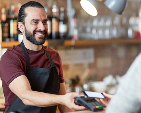 customer service - barman and woman with card reader and smartphone