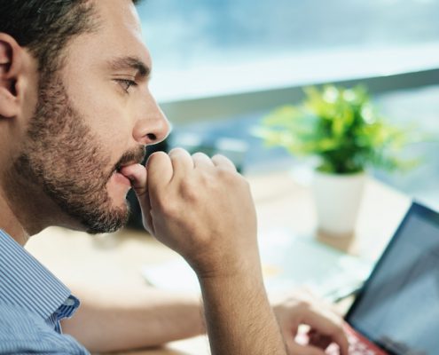 Anxious Businessman Biting Nails Working With Business Data Loss