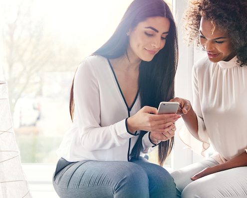businesswomen checking mobile marketing for business